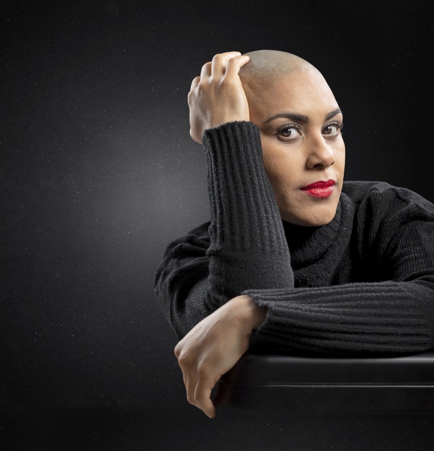 Bald woman on black background