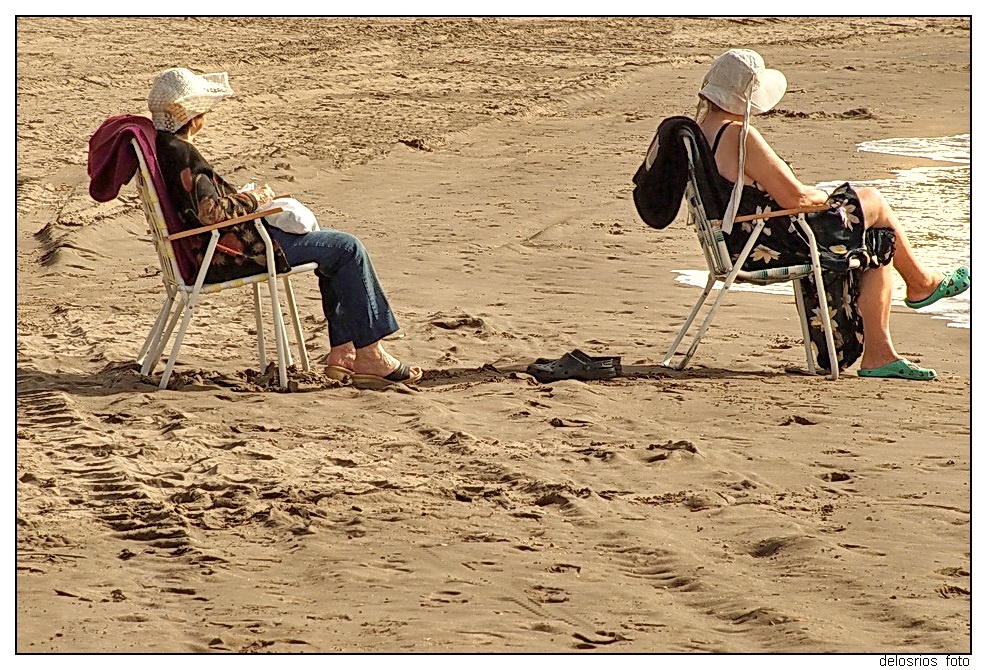 "`Dos seoras sentadas en linea observan el mar`" de Cristian de Los Rios